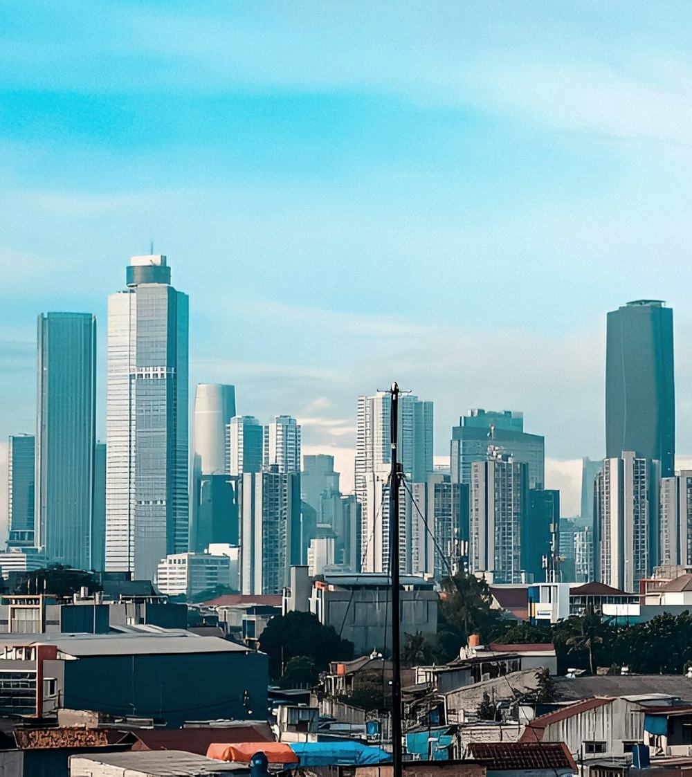 Gedung-gedung tinggi di atas atap permukiman Jakarta